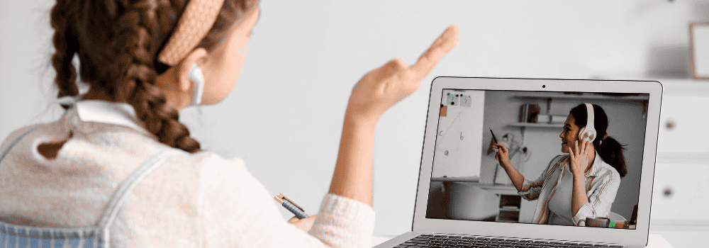 Teen tutoring on her laptop in her room