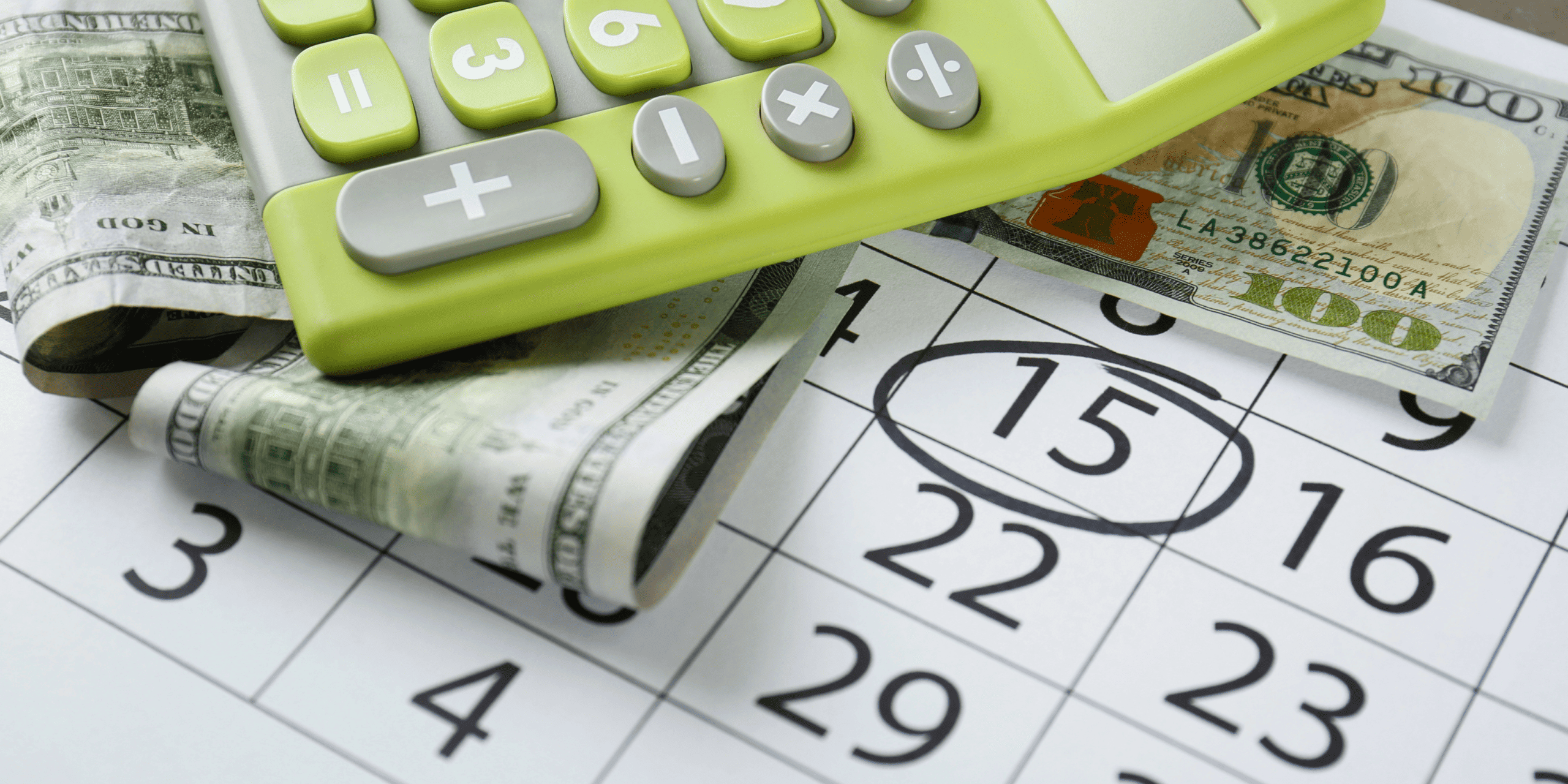 Calculator with money and calender on desks - Teen SPending Tracker