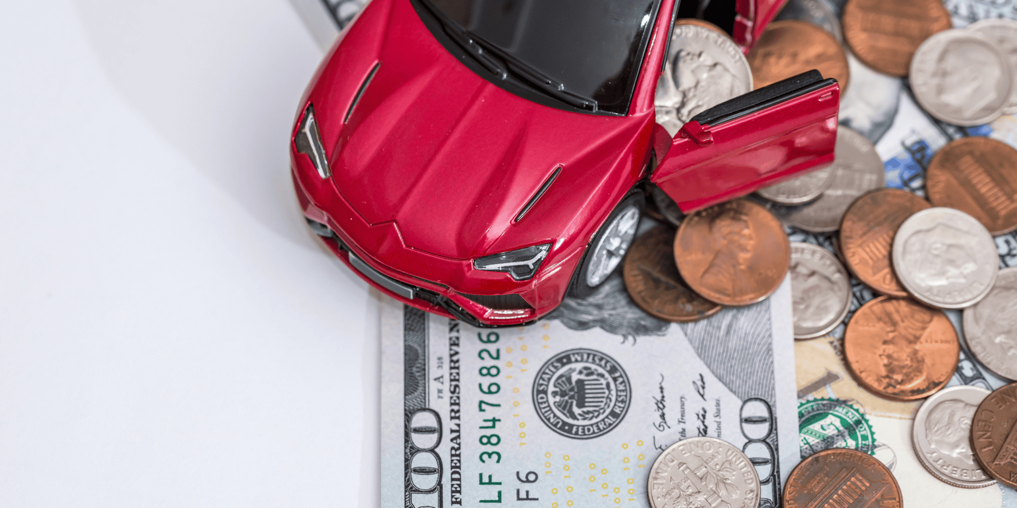 Money and toy car on desk