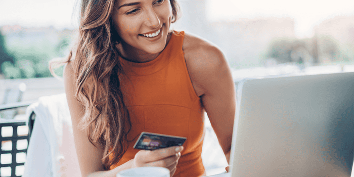 Teen holding credit card while shopping online - Teen Online Shopping Tips