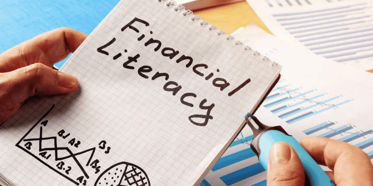One notepad and several budget sheets laying on a table/financial literacy gifts