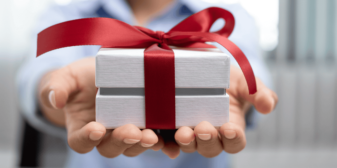 A big gift being held by hands/financial literacy gifts