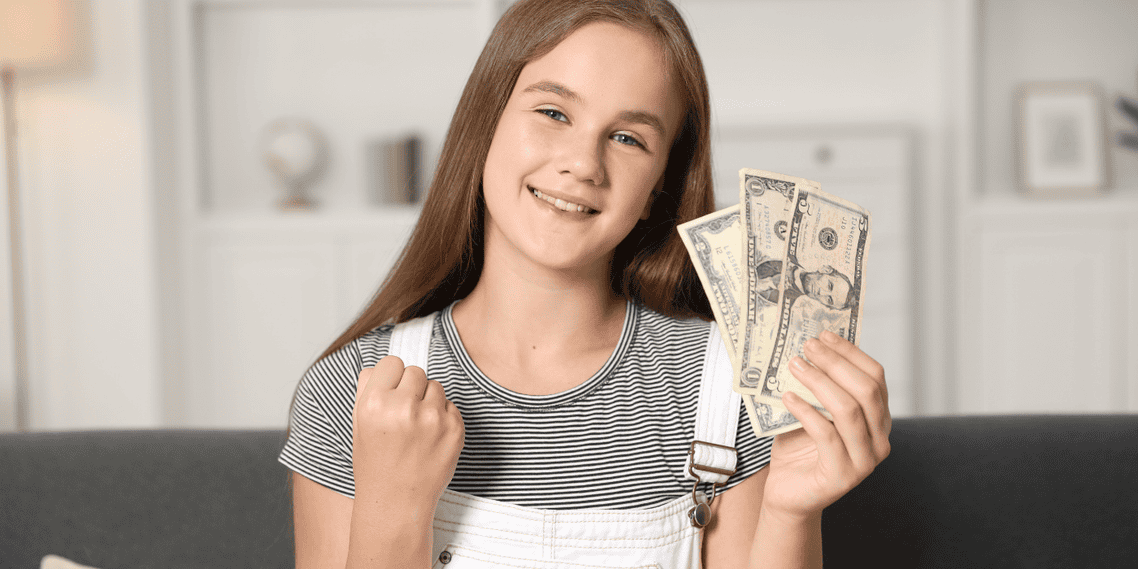 Young girl hold USA cash in her hands/financial literacy gifts